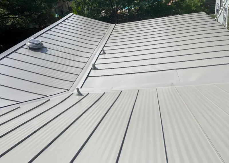 Solar attic fan installed on a metal roof for Roof Ventilation in East Chicago